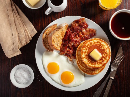 Fresh breakfast spread with eggs, toast, and pastries